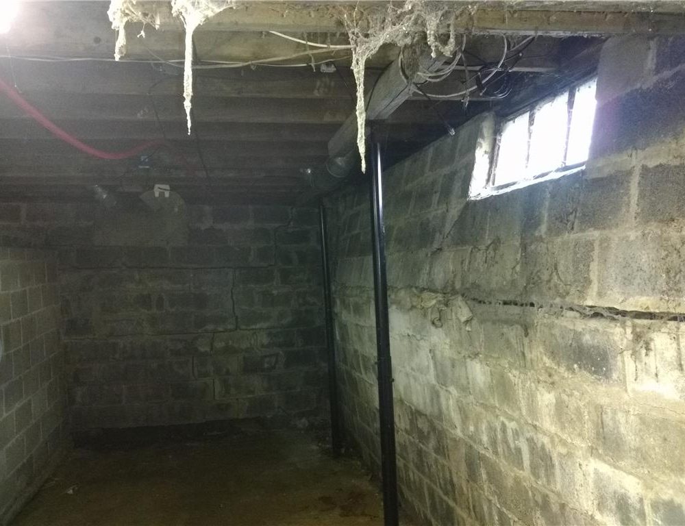Bowing basement wall in Rochester, MN showing visible inward movement before foundation repair