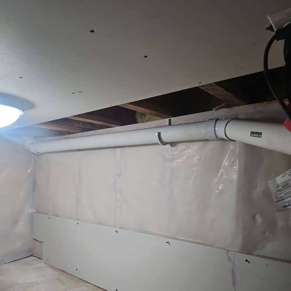 Interior basement waterproofing system with vapor barrier and drainage setup in Rochester MN basement